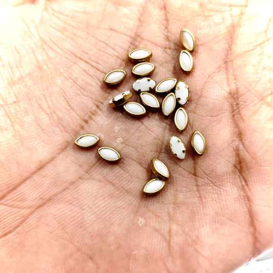 Premium 3x6MM eye shape pearl white fitting stones with gold finish. Perfect for Aari work, silk thread bangles, jewellery making and craft. Elegant, lightweight and easy to fix. Available in 20g & 50g packs from Kavitha Enterprises.